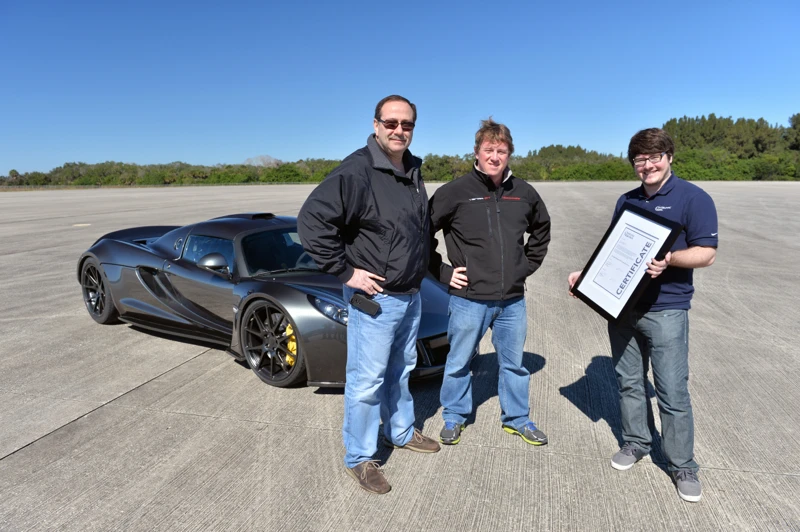 The Hennessey Venom GT team with verification certificate