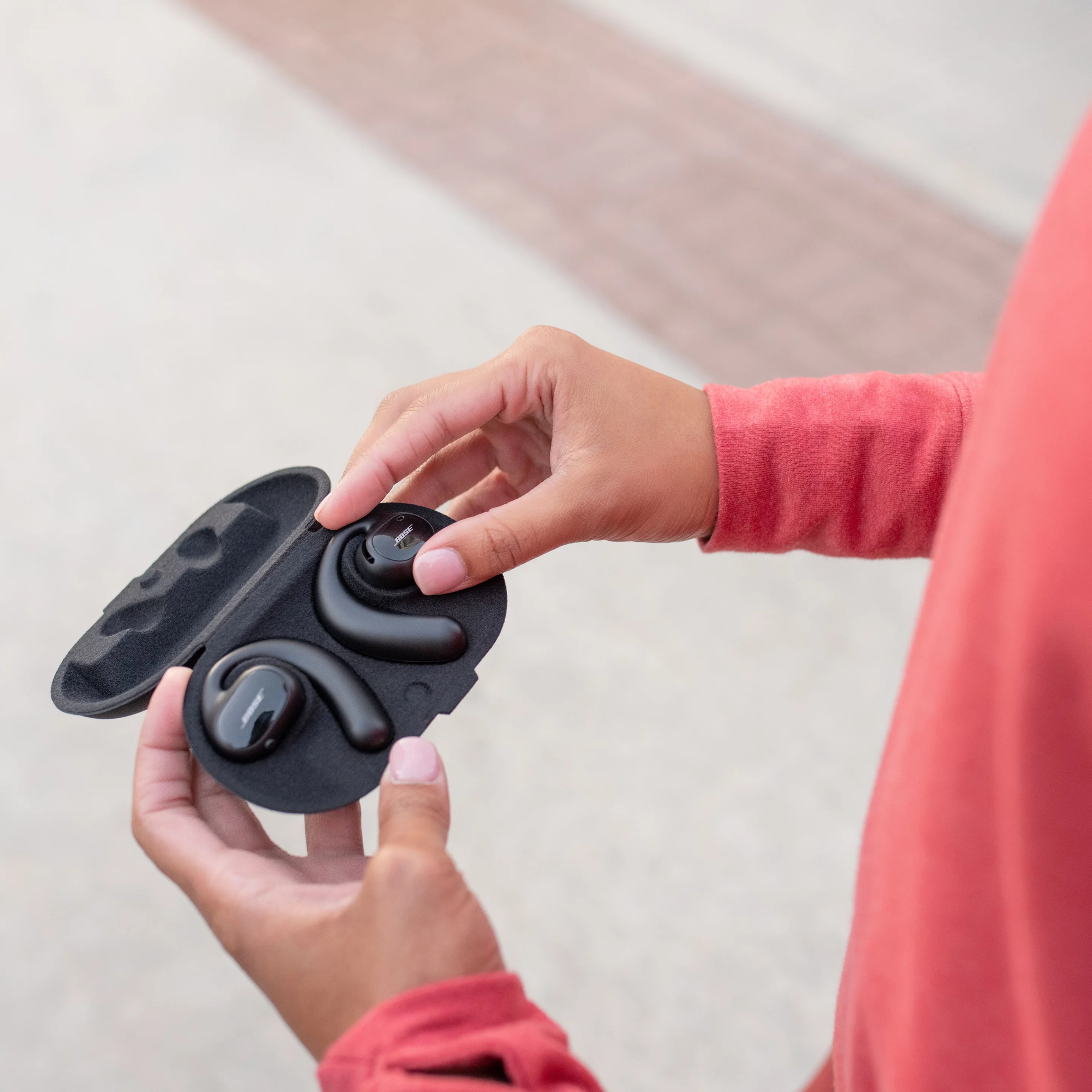 The Sport Open Earbuds ship with a carry case and charging base