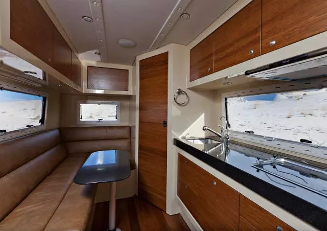 The galley includes a recessed stove, sink, refrigerator and microwave