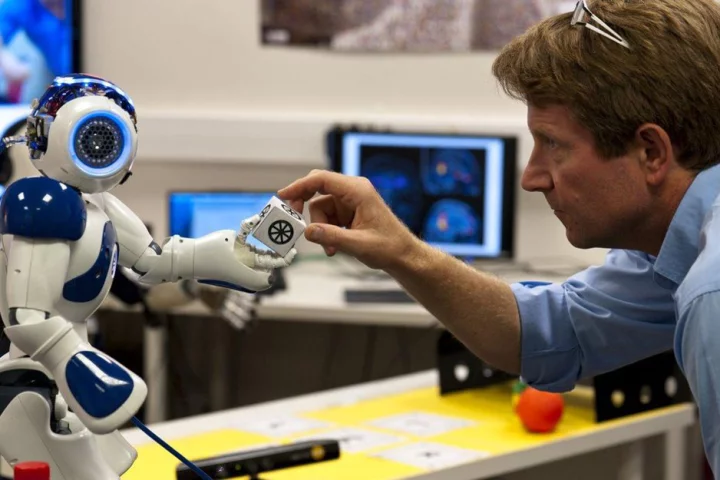 Peter Ford Dominey and the robot Nao interact in order to store "autobiographical memories" of how to recreate similar tasks, potentially in a situation aboard the ISS