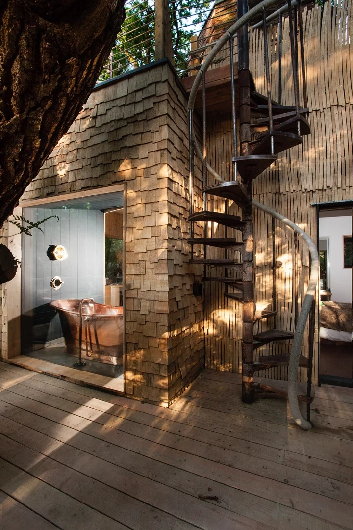 The Woodsman's Treehouse sports a spiral staircase to access the sauna and hot tub