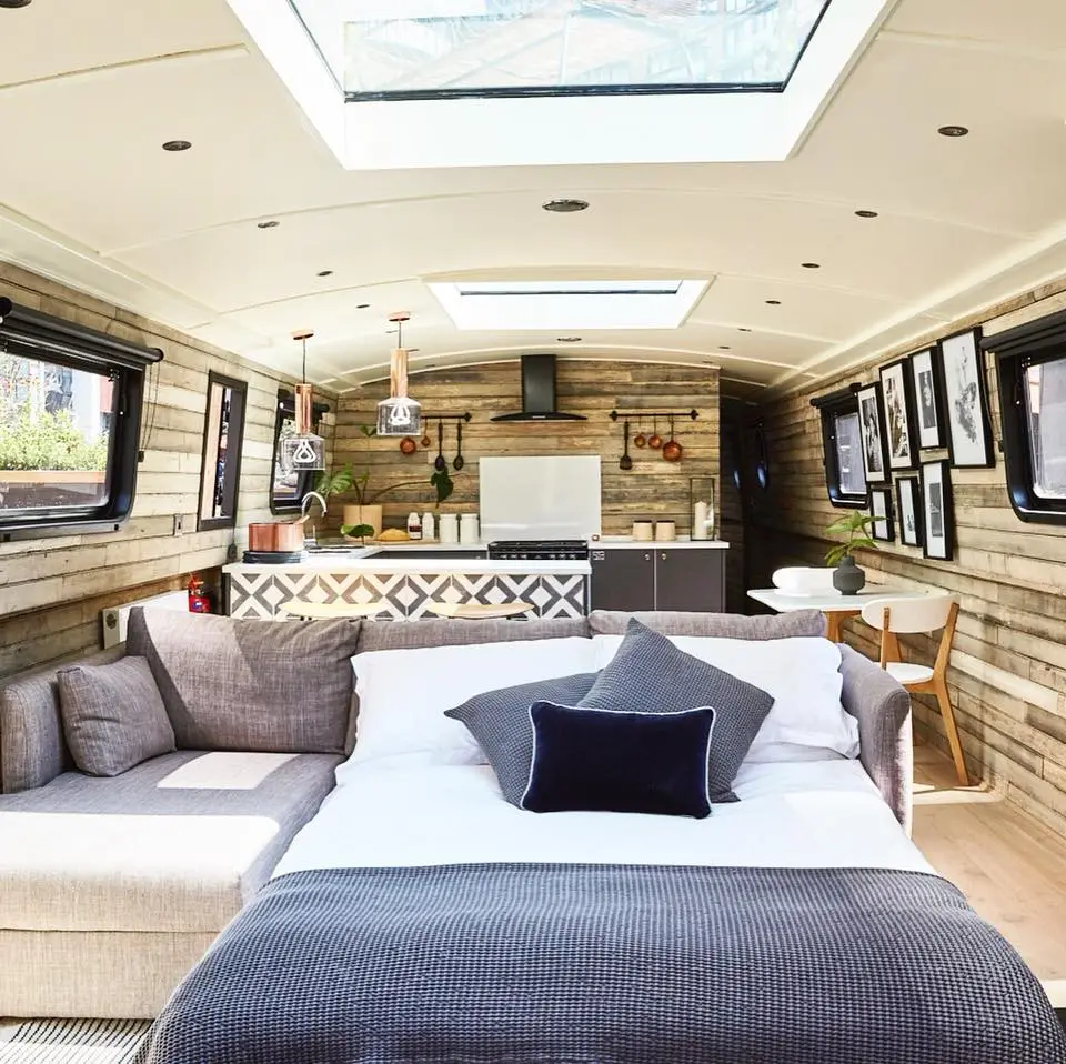 The Boathouse London features an open living area with large sofa that can covert into an additional double bed