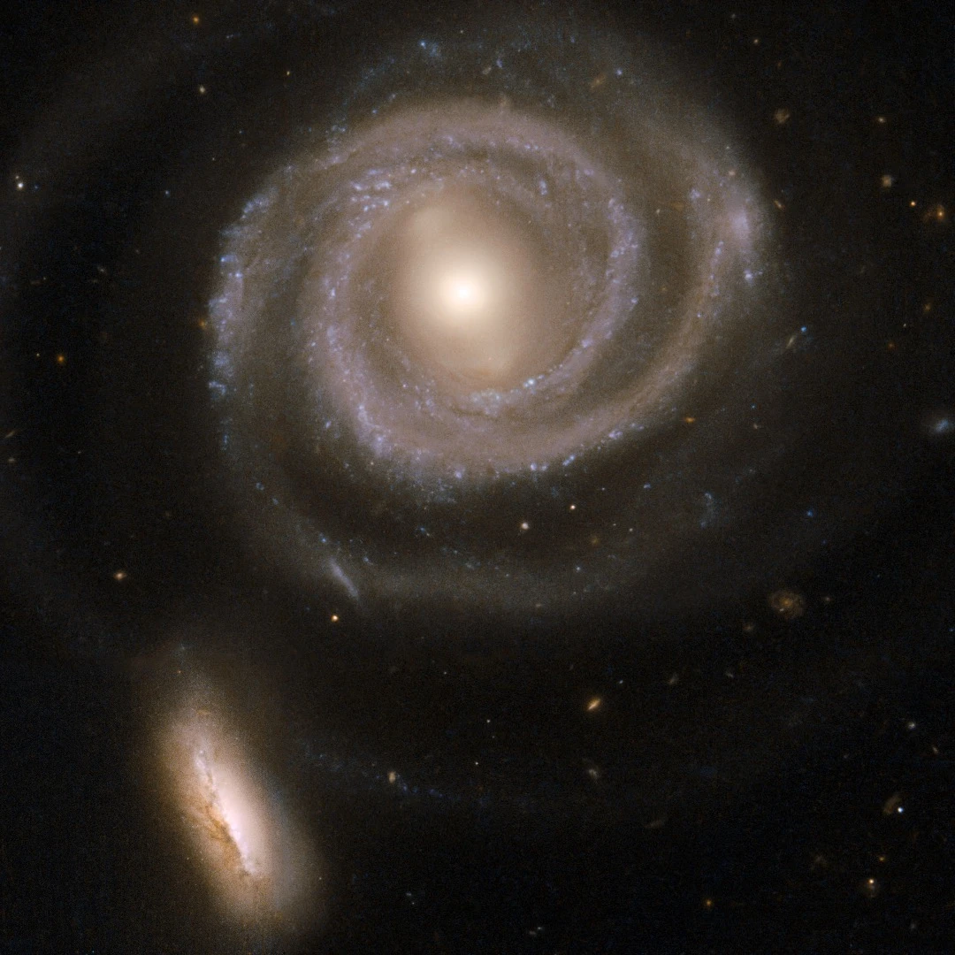 This pair of interacting galaxies consists of NGC 5754, the large spiral on the top and NGC 5752, the smaller companion in the bottom left corner of the image