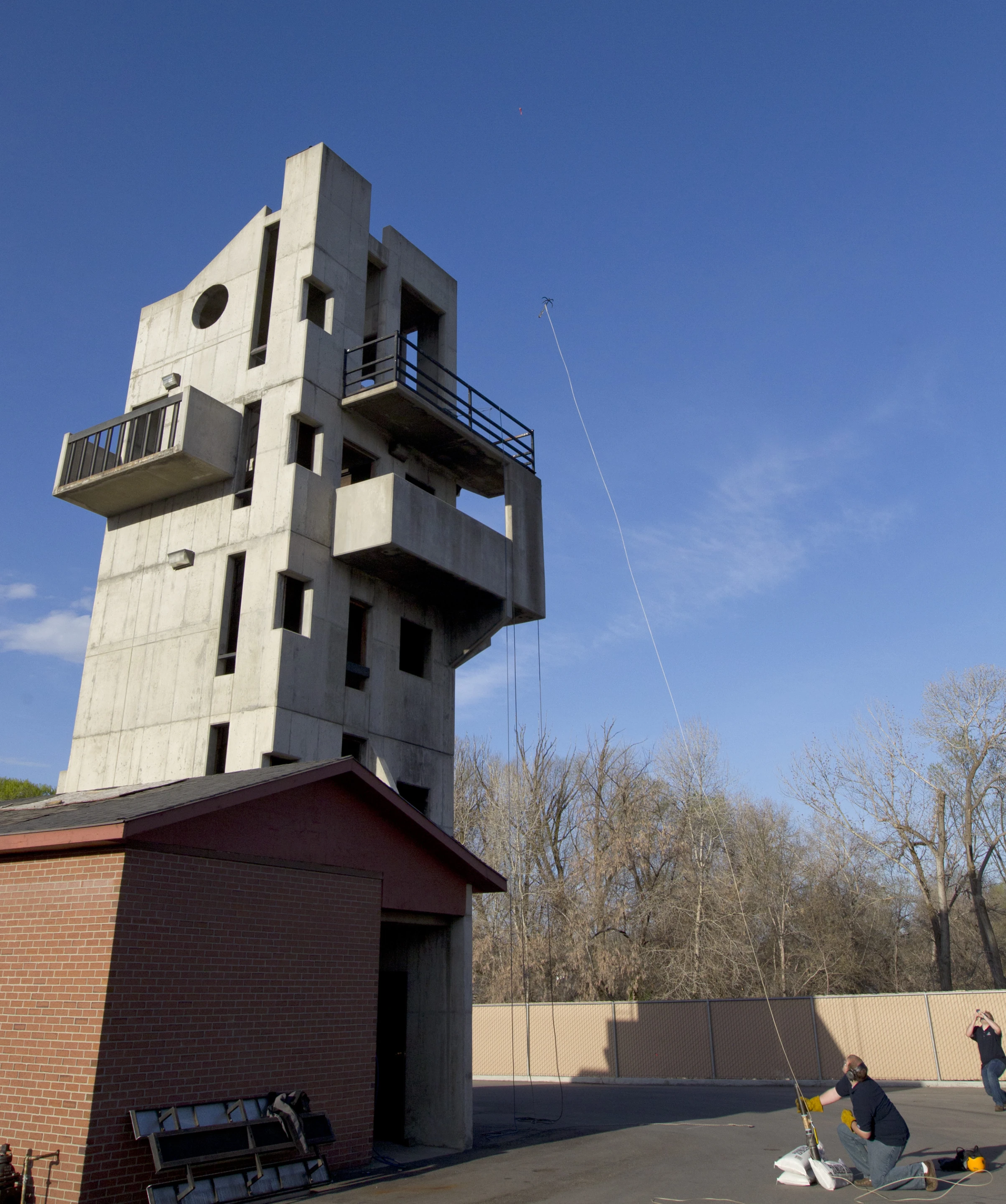 Students demonstrate the launch of a grappling hook from a pressurized air cannon