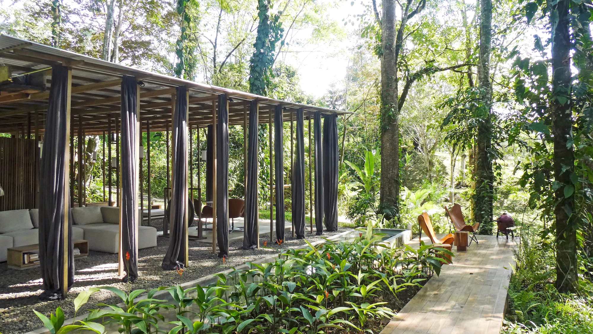 The Open Jungle House's open design lets in the elements, though it does have some curtains installed for shelter from heavy rains