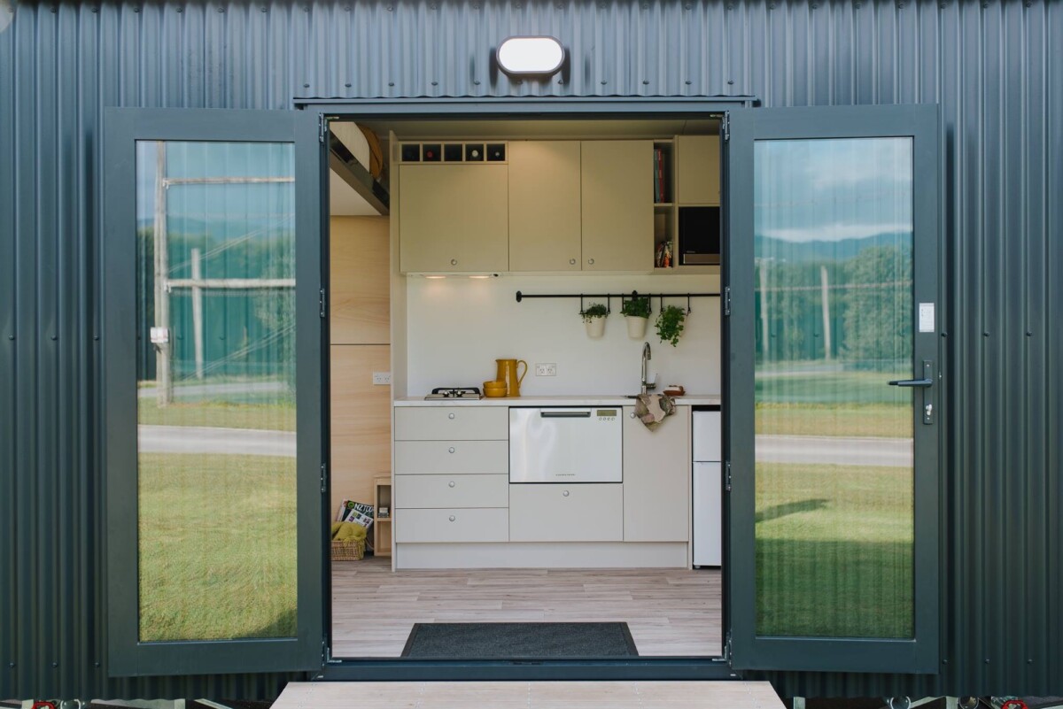 The Camper Tiny House is accessed by double doors