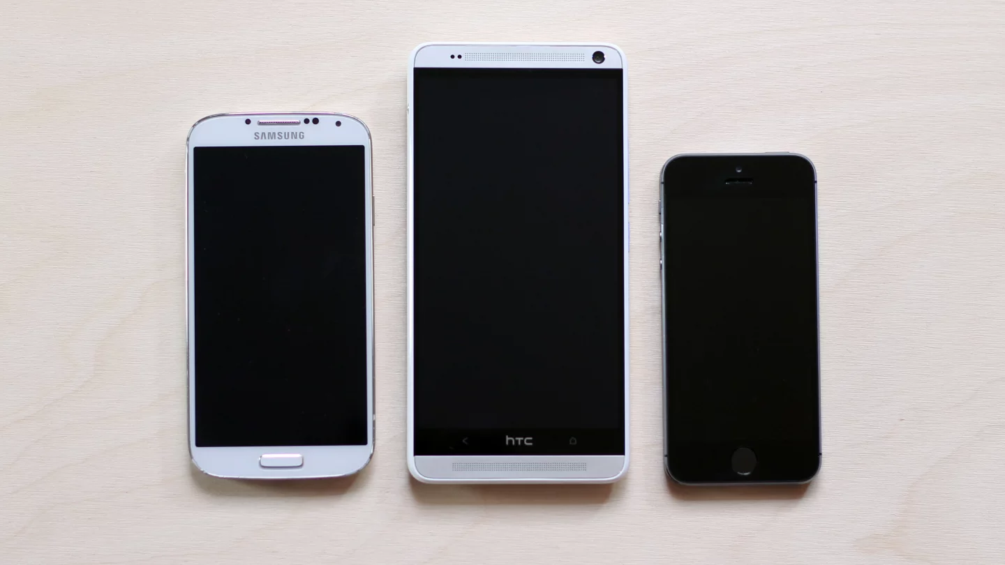 The One max towers over the Galaxy S4 (left) and iPhone 5s