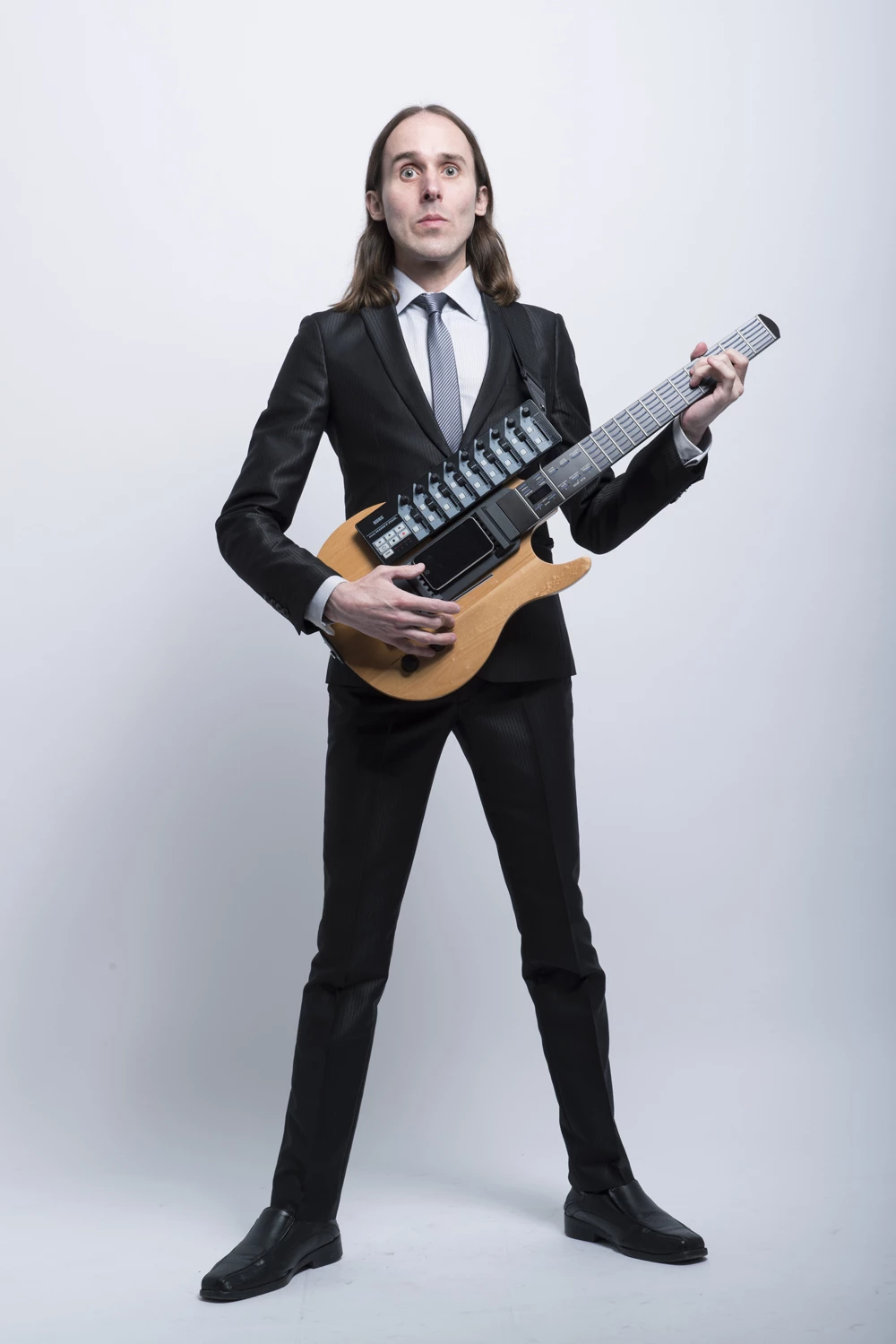 Uni Sun, who performs as Omni Infinity, has launched a guitar-shaped digital controller/instrument called the SPACEBASS:01