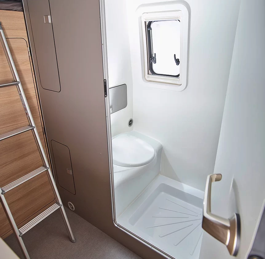 The Alphavan wet bathroom appears to be fairly spacious thanks to the fixed toilet, pull-out sink and square shower floor
