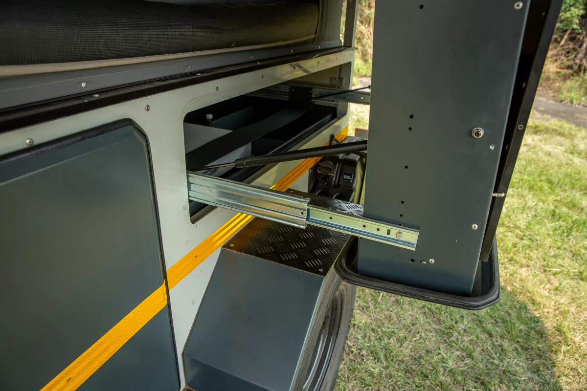 The kitchen unit features slides and strut-assisted folding
