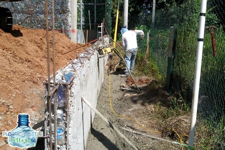 Building a plastic bottle-filled home