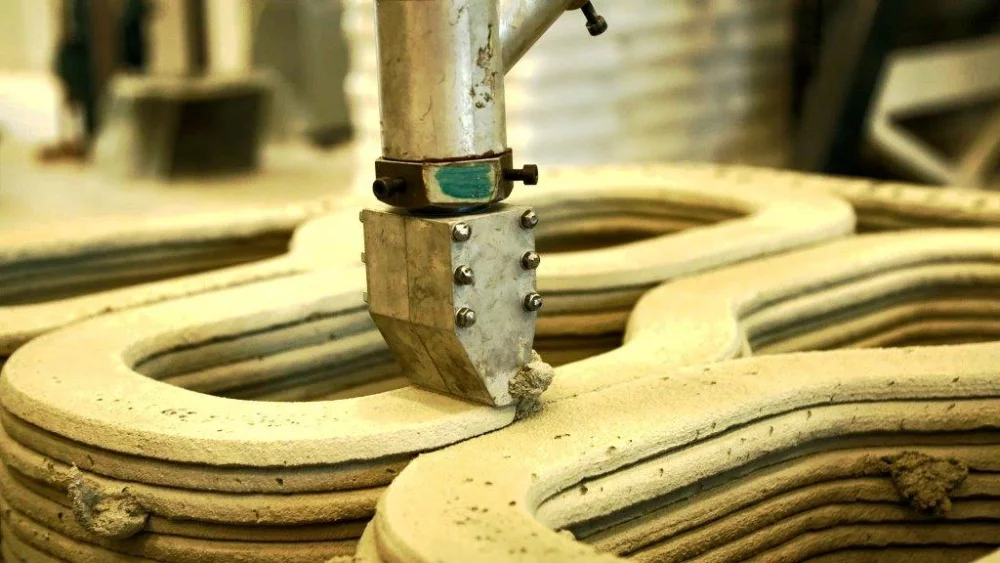 The bridge was 3D printed at Eindhoven out of cement, with steel cables laid in each layer by the print head before the cement was dry