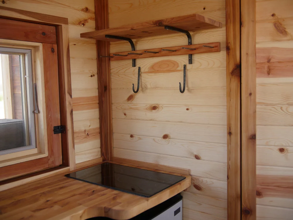 The Honey on the Rock's kitchen includes cooktop, sink, fridge/freezer, and spice racks