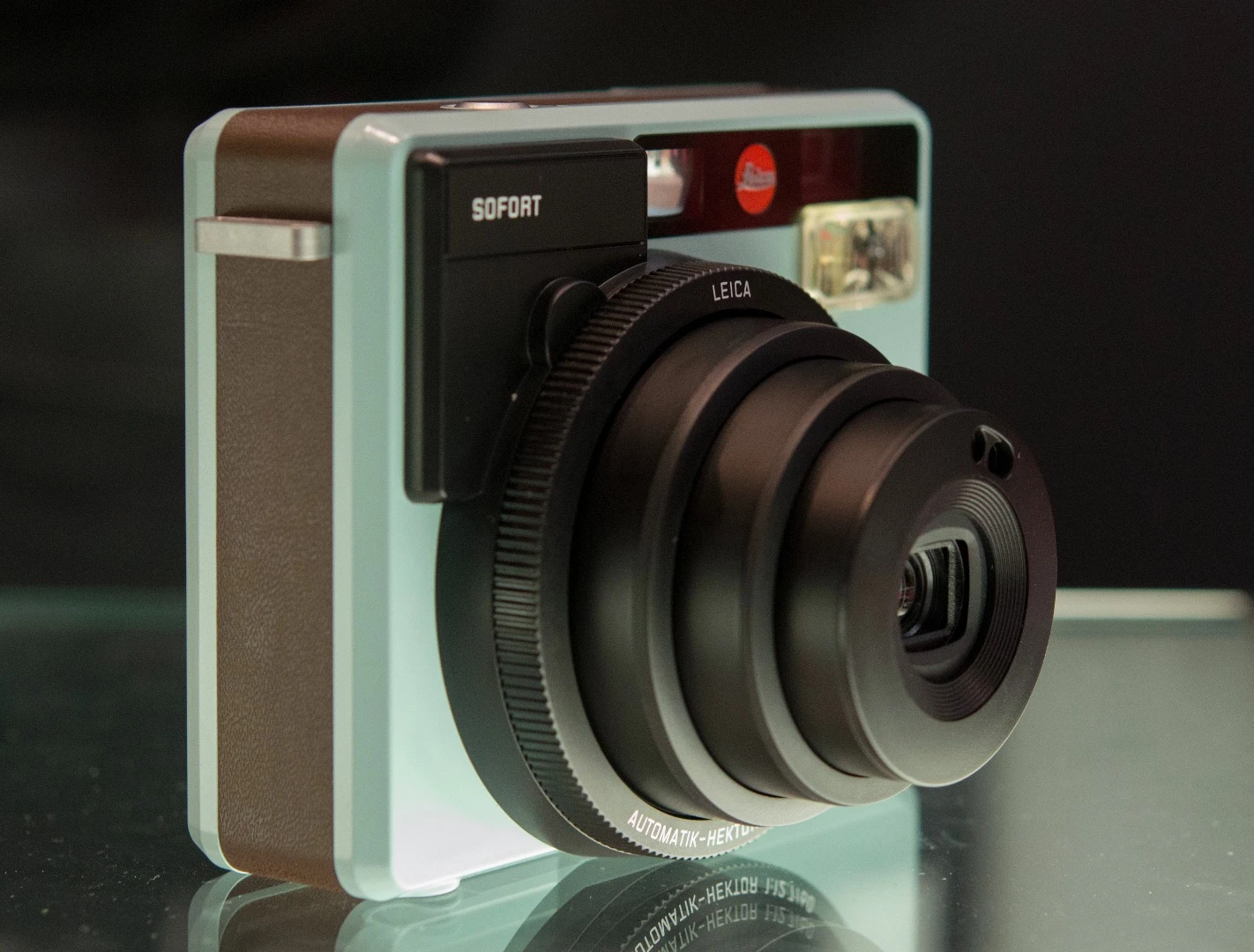 The lens extends from the Leica Sofort instant camera when it is powered on
