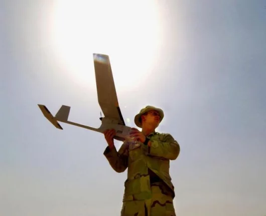 Cpl. Jerry Rogers, from the 1st Armored Division, prepares to launch a Raven unmanned aerial vehicle over Taji, Iraq.