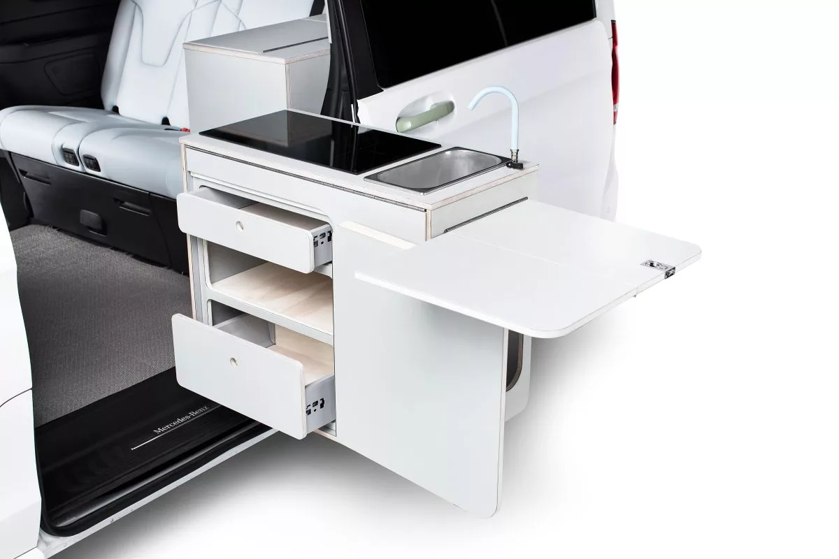 The indoor/outdoor swinging kitchen is a signature component of Tonke camper vans, and the EQV Touring's goes fully electric