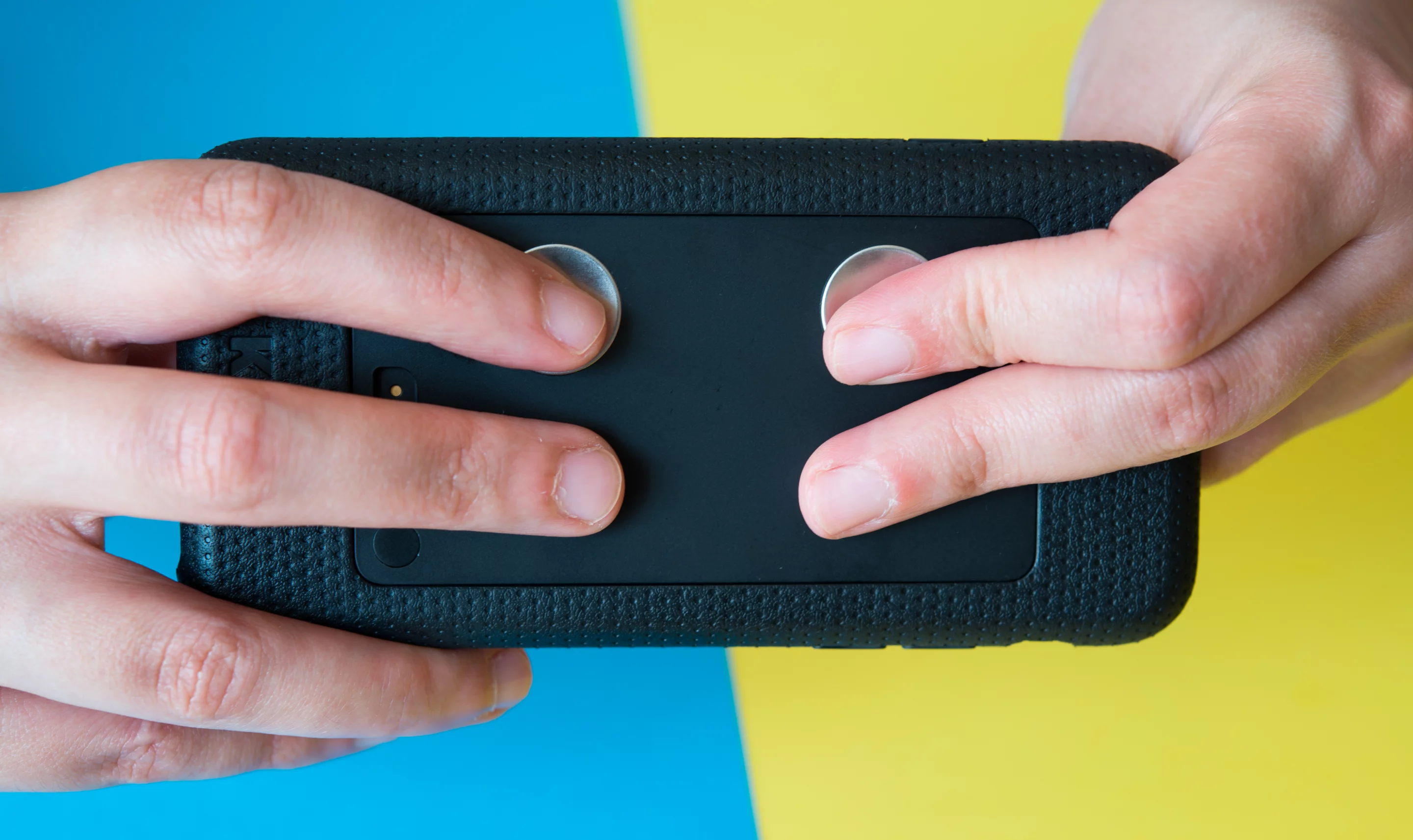 Users place four fingers on the sensors of the Kito+ health tracker to take a reading
