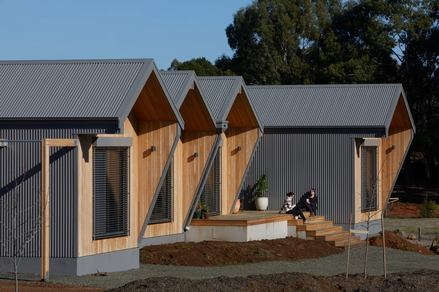 Adjustable shutters and landscaping help keep the home cool throughout the day