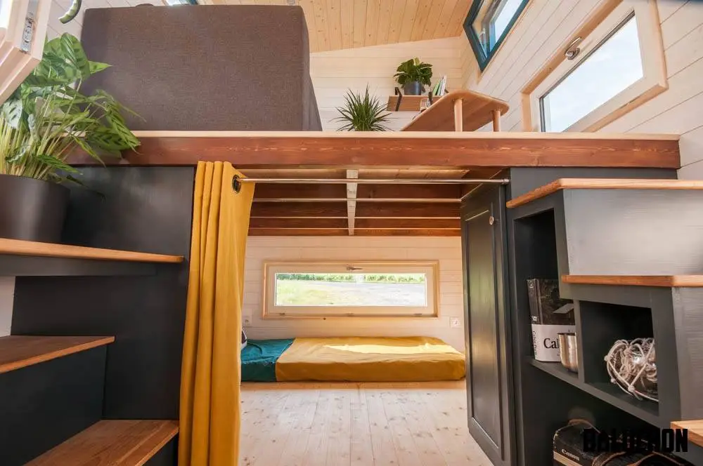 The Valhalla's downstairs bedroom is located underneath the living room and given privacy by curtains