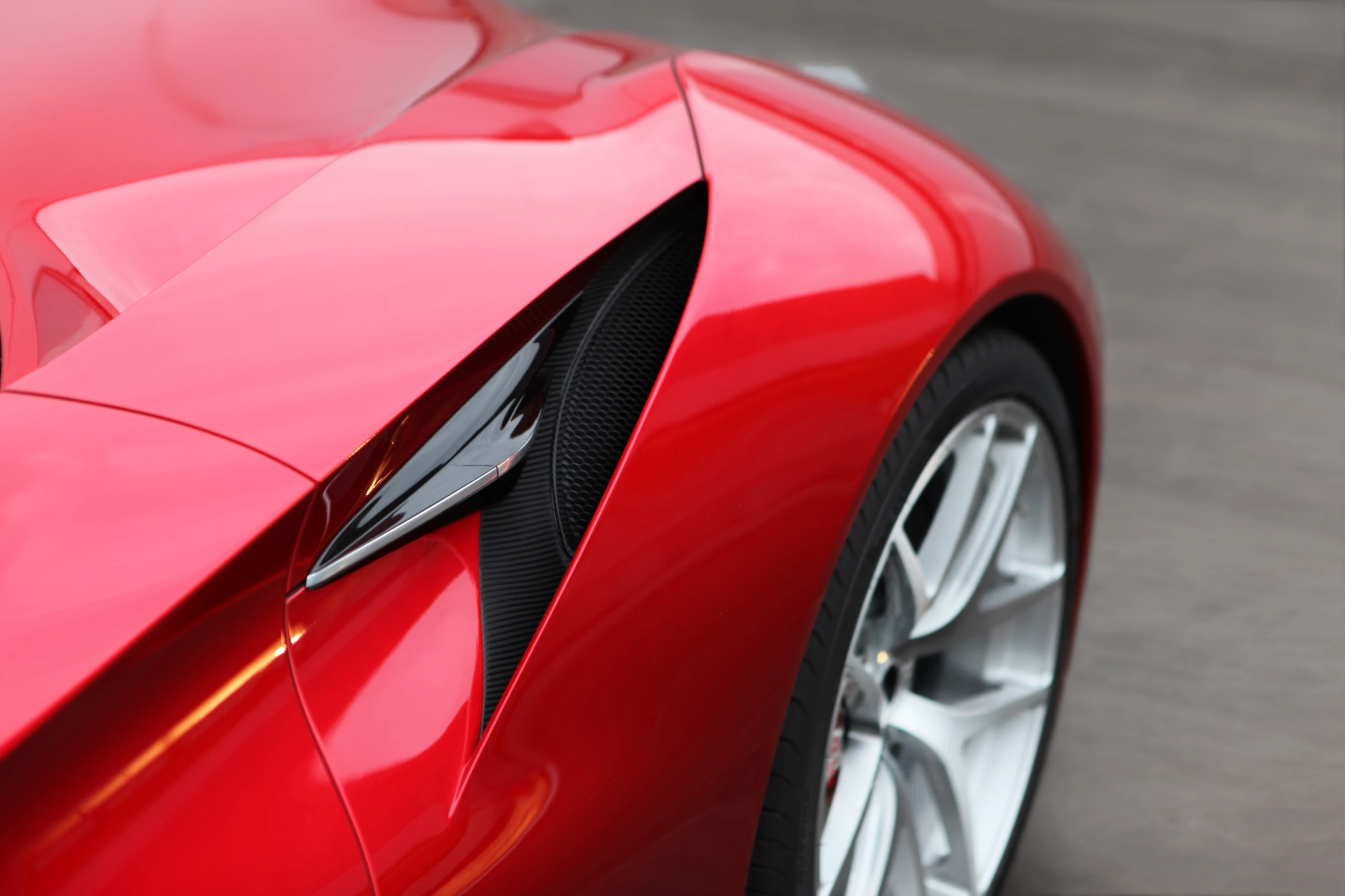 Open haunch venting assists with removing excess heat from the V12's engine bay