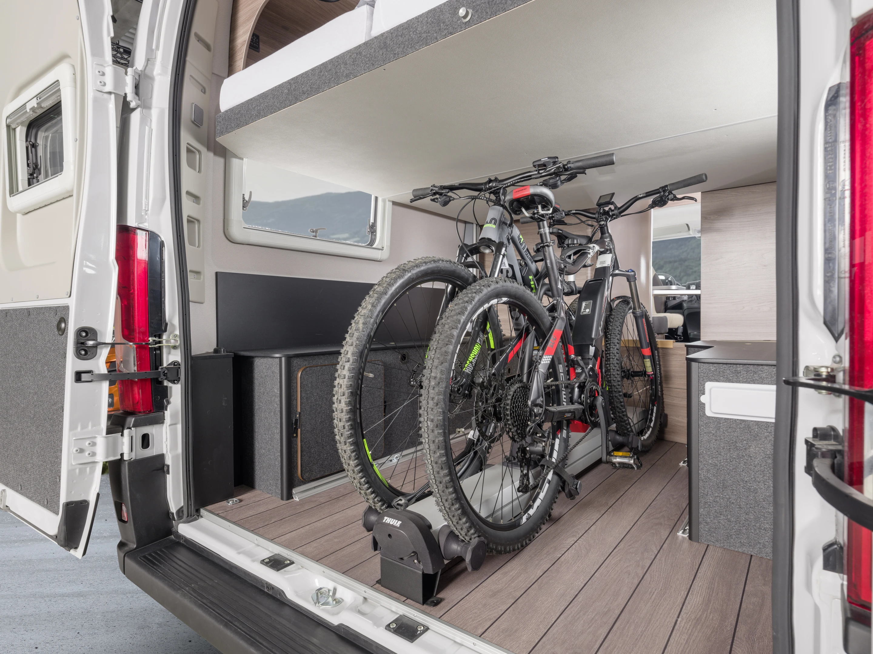 The Boxlife 630 ME's standard multi-adjustable rear bed lifts out of the way for bike hauling