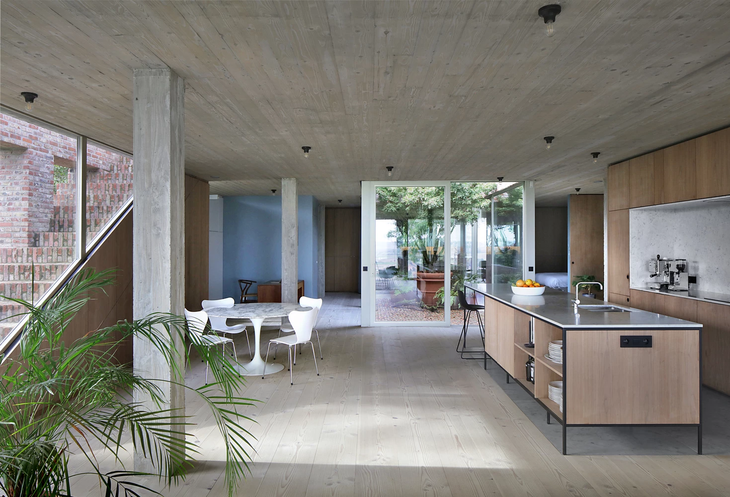 The central living quarters have a simple interior aesthetic with natural tones