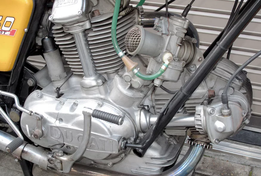 This 1974 Ducati 750 Sport offers the best of both worlds in that it was fitted with 750SS Desmodromic cylinder heads during the 1980s by Ducati's defacto race department of the seventies, NCR.
