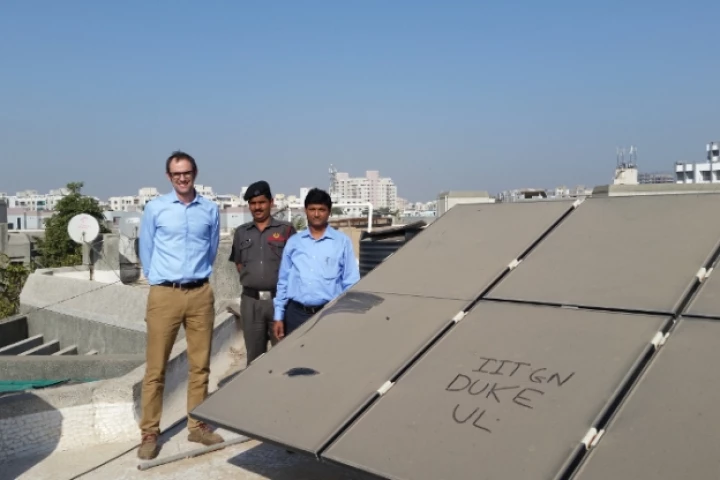 Duke engineering professor Michael Bergin (left) stands with Indian Institute of Technology-Gandhinagar colleague Chinmay Ghoro next to a dusty solar array