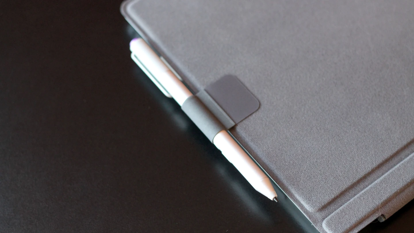 The Type Cover now has a little loop (which you have to attach yourself) that you can slide the pen into