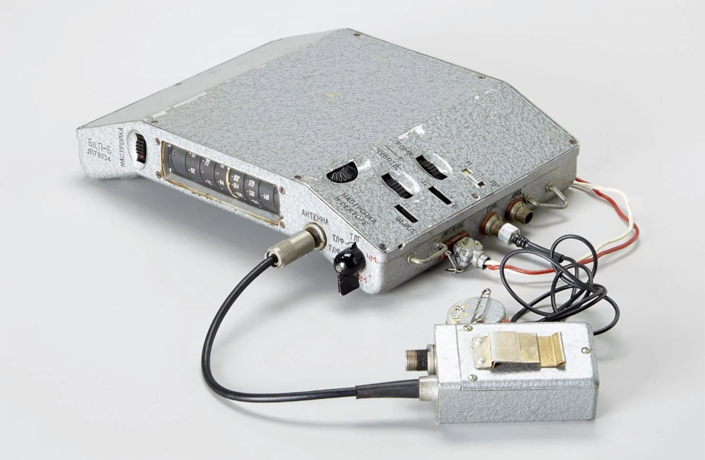 This Soviet-made body-wearable Filin Type B (wide-range 60-150 MHz) intercept receiver, was used by the Stasi (short for Staatssicherheit, being the feared East German Secret Police) to eavesdrop upon and pinpoint the source of enemy communications during the "Cold War." The curved design enabled the device to be worn on the chest so it could be hidden under clothes and the agent used a disguised headphone (3 cm in diameter and pictured between the main units above) attached on the inside of his collar. The cryptomuseum website has a complete technical rundown on the device.