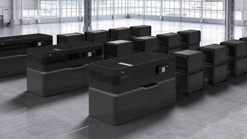 Desktop Metal production system. Each printer (left) runs so fast it needs up to four hybrid furnaces for sintering