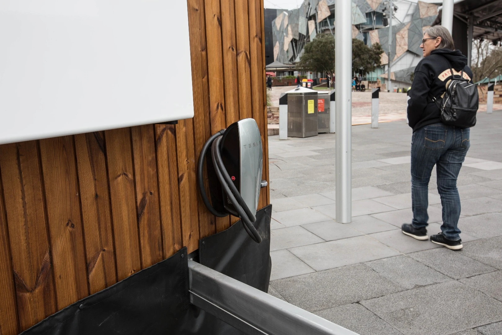 A charger for the Model X is attached to the side of the Tesla Tiny House