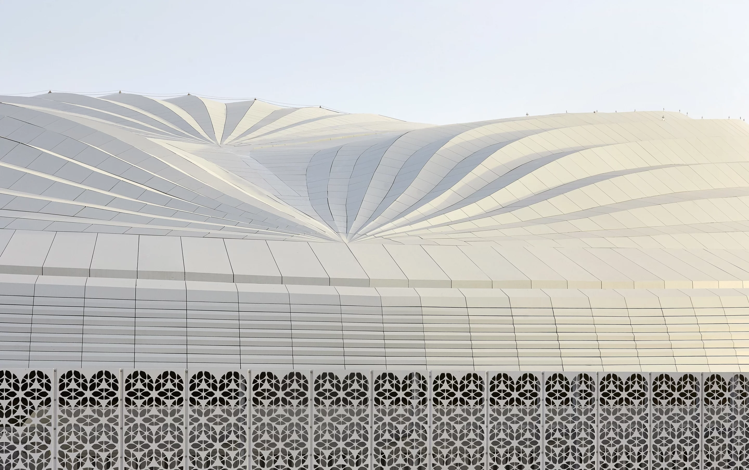 Al Wakrah Stadium's exterior features a bronze latticed screen inspired by traditional Islamic craftsmanship