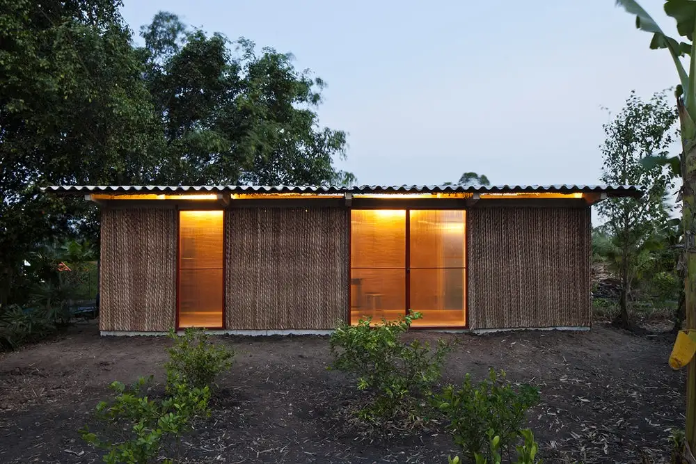 The S House by Vo Trong Nghia Architects comprises a pre-cast concrete frame and foundation that's bolted together with steel fixings, plus a cement roof. It also features steel doors and window frames, and easily-obtained local materials such as Nipa Palm leaf thatching and bamboo that are used to finish the home