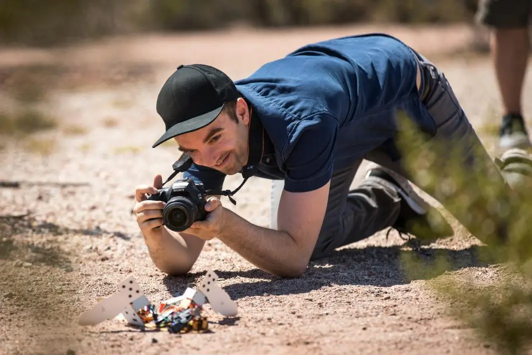 Team member Heni Ben Amor looks on as the C-Turtle robot tackles the terrain in Arizona's Papago Park