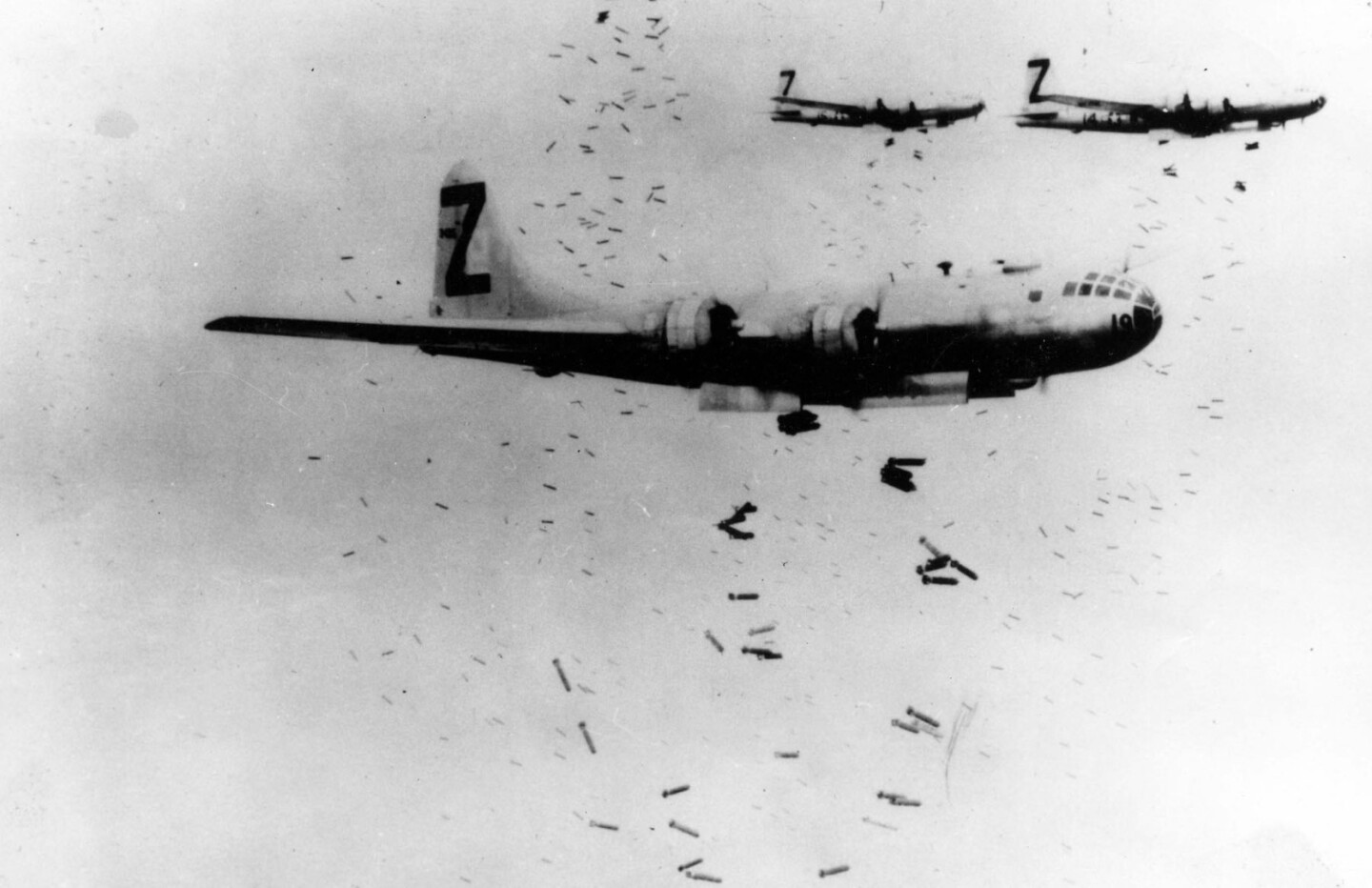 WWII began just 25 years after WWI but the march of technology had seen the bi-planes of WWI replaced by a vast array of purpose-built war planes. Initially, during WWI, aerial bombing began as hand-grenade type bombs which the pilot quite literally threw at the enemy below from his cockpit. By WWII, a single long-range bomber such as the Boeing B-29 Superfortress could deliver 20,000 lb (9,000 kg) of bombs, and a fleet of bombers was capable of carpet bombing vast tracts of civilization back to the Stone Age in an evening.
