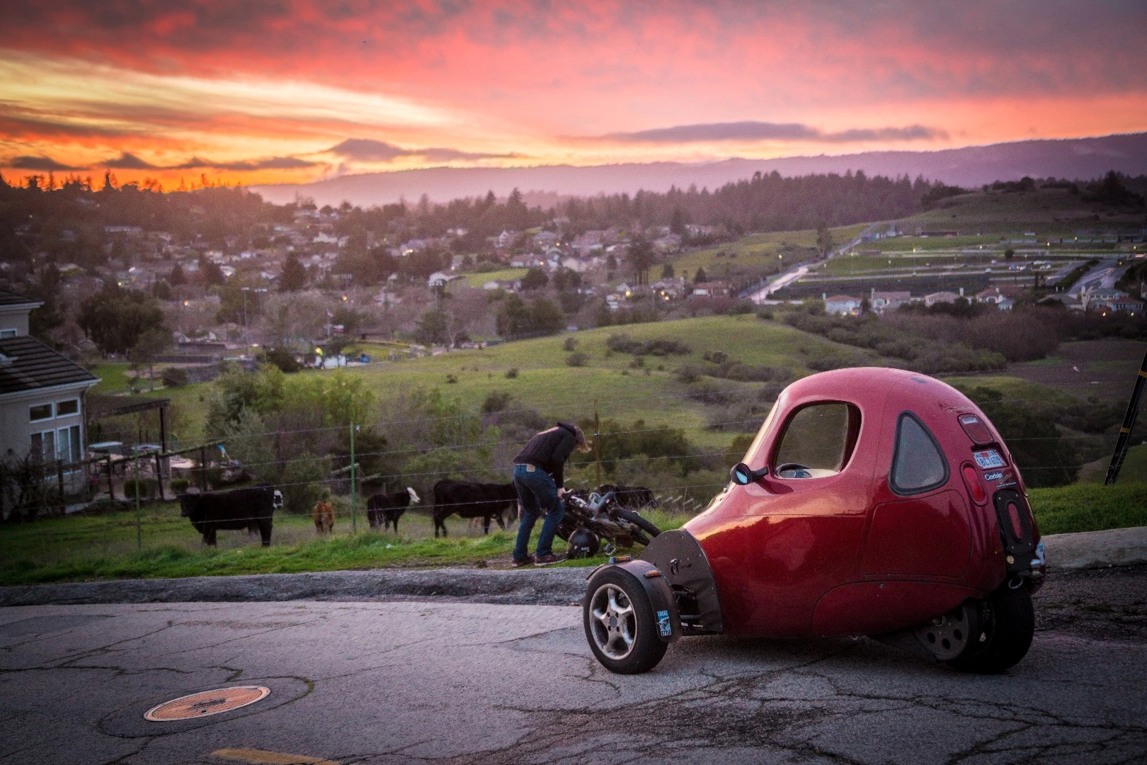 Luke Workman picks up a dropped Death Bike, looking out over the hills near Santa Cruz.