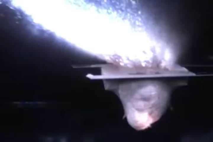 A frame from the video of the Brown team's hypervelocity impact experiment, which found that water-rich asteroid collisions can transfer a surprising amount of water to a dry surface