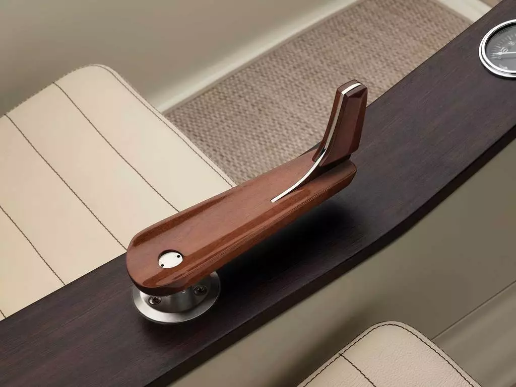 Steering is controlled via a hand-carved wooden tiller