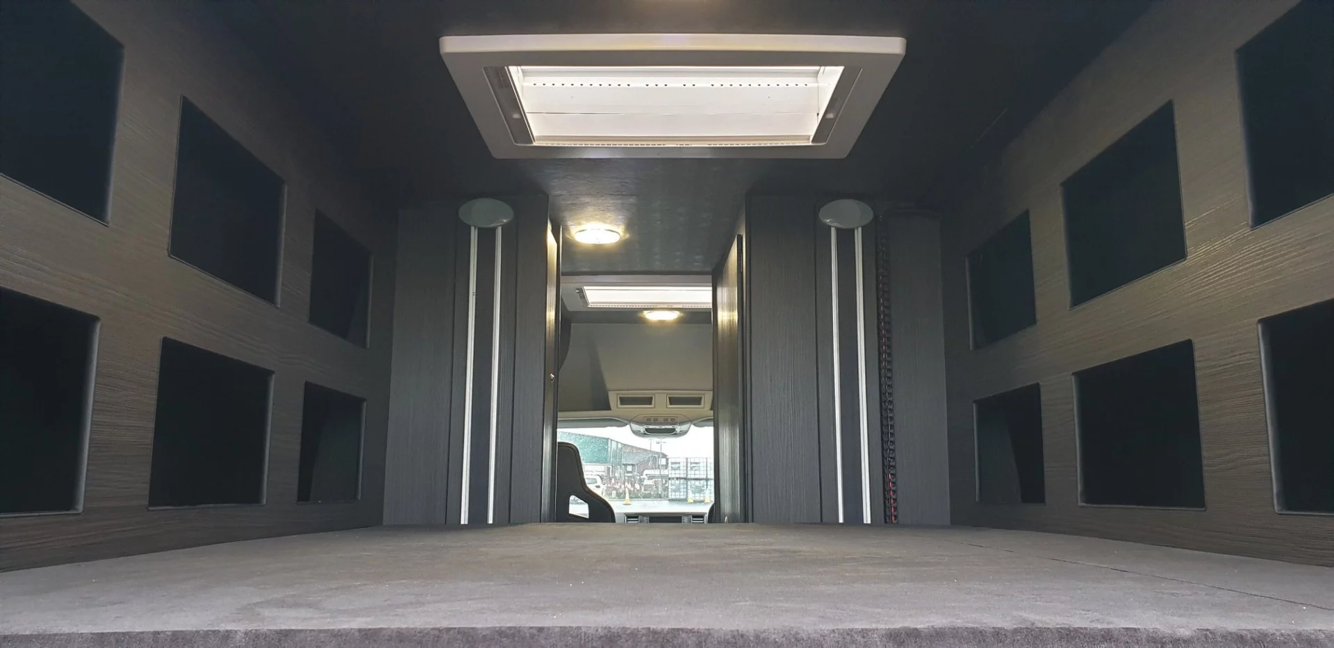 The lift-away bed creates a cozy rear bedroom with integrated storage compartments