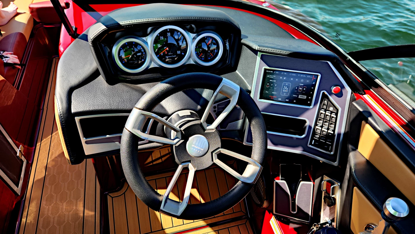 The cockpit of the MasterCraft X24 with gauges at center, the SurfStar system at right, and the throttle to the far right