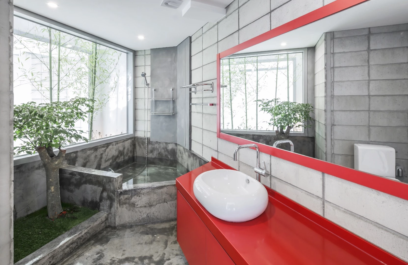 The Flying House's bathroom includes a concrete bath and a small tree