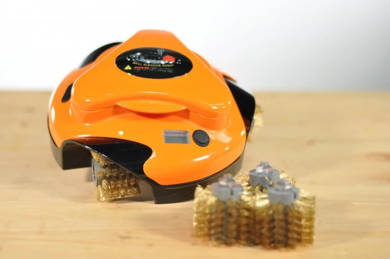 Grillbot is a robot powered by three electric motors that uses three replaceable brushes to scrub clean your grilling surface