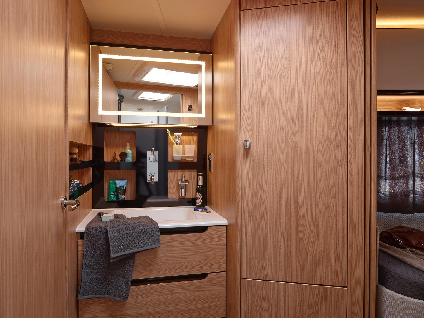The bathroom includes a shower/toilet room and separate sink area