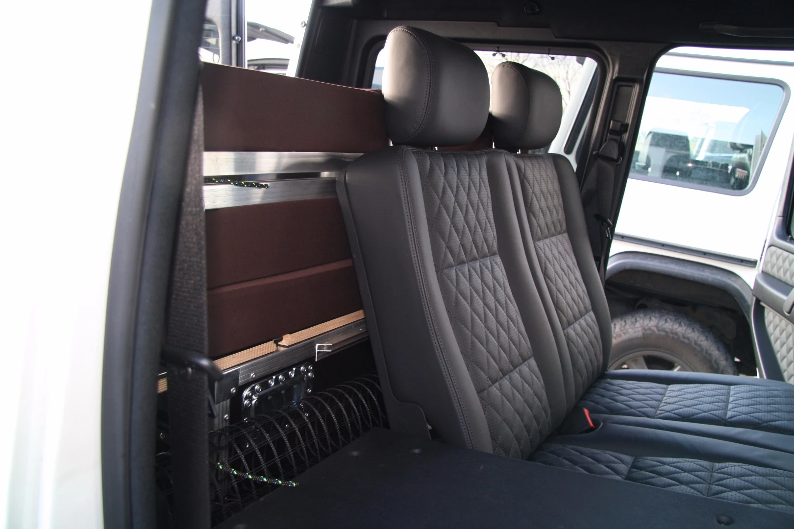 During travel, the bed folds up to allow use of the back seats
