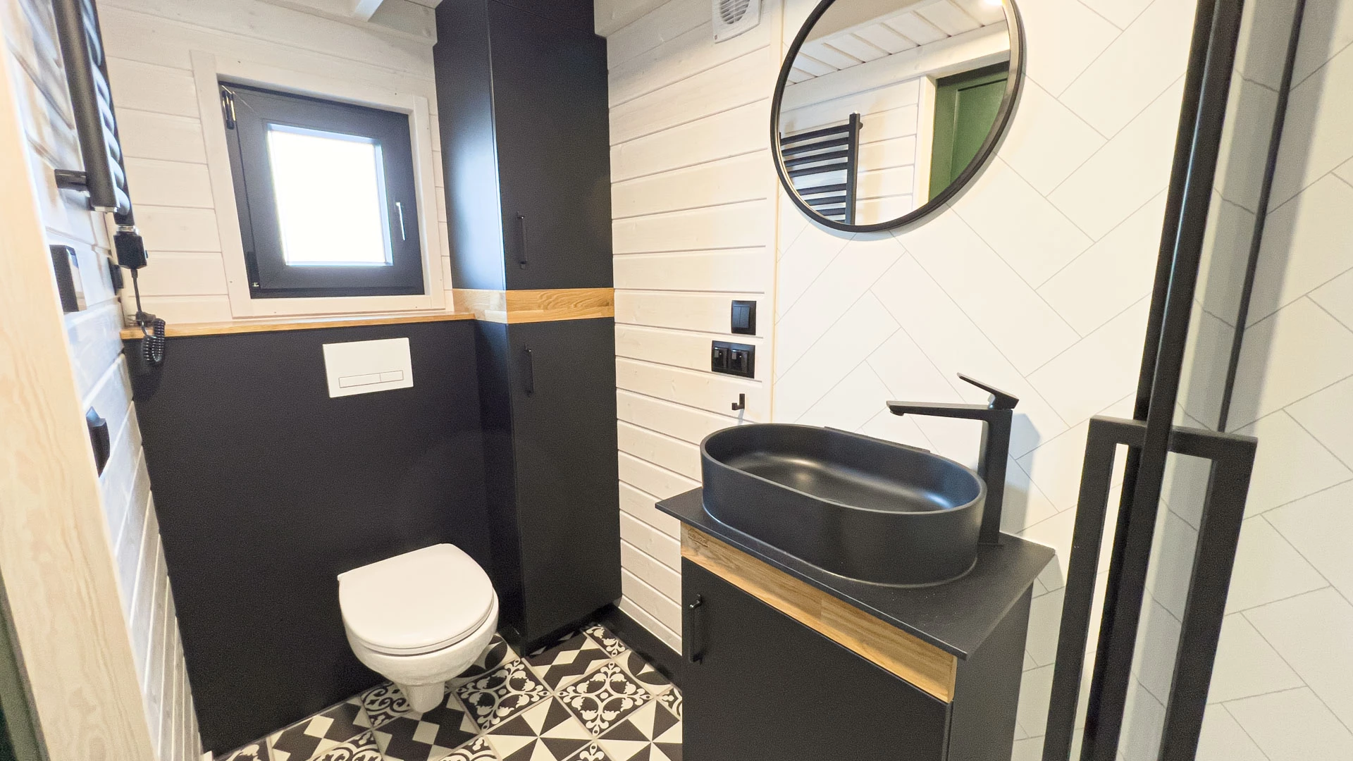 The Mobi Individual Baobab's bathroom is small but includes a shower, vanity sink, and a flushing toilet
