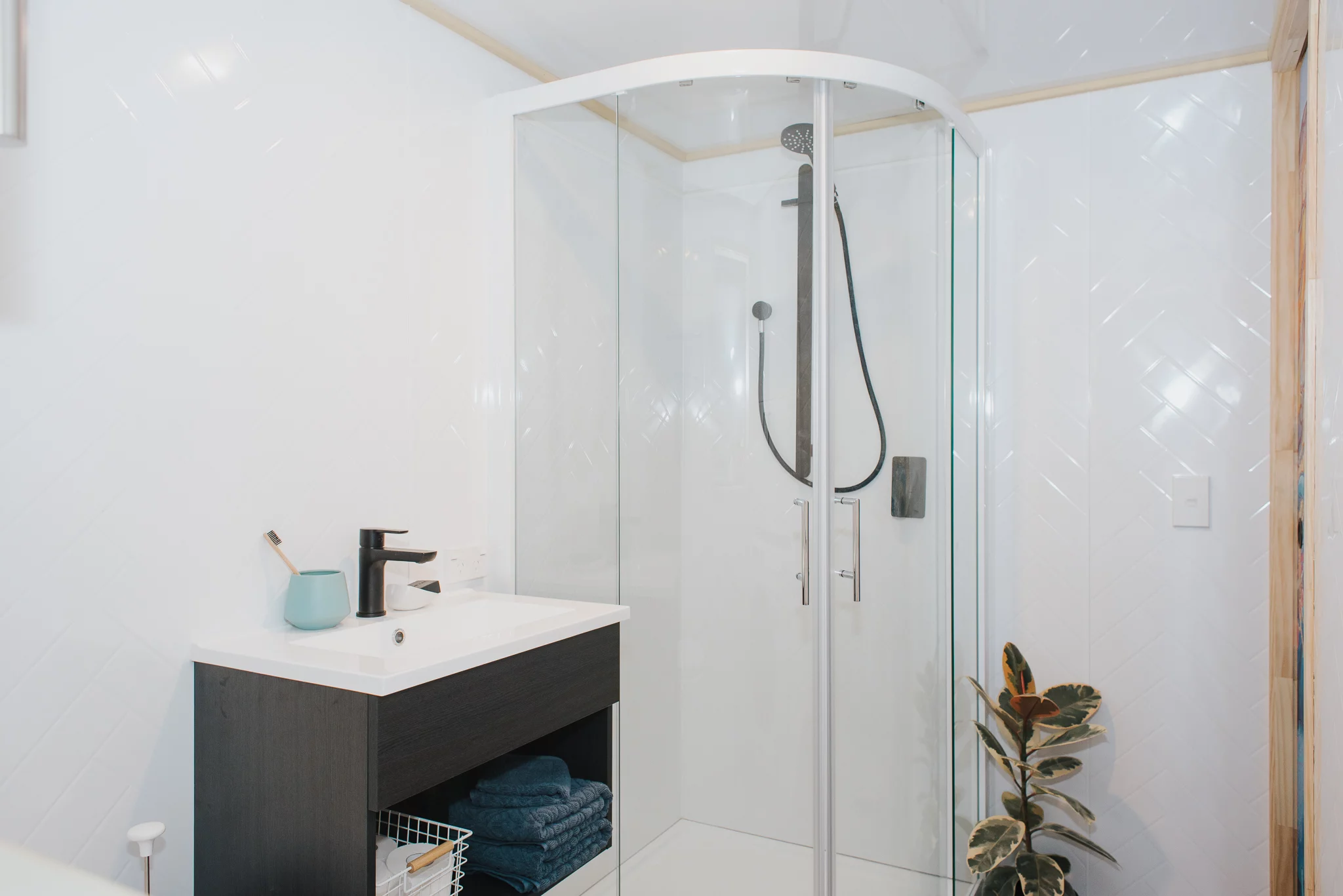 The Autumn's bathroom includes a corner shower and a small sink