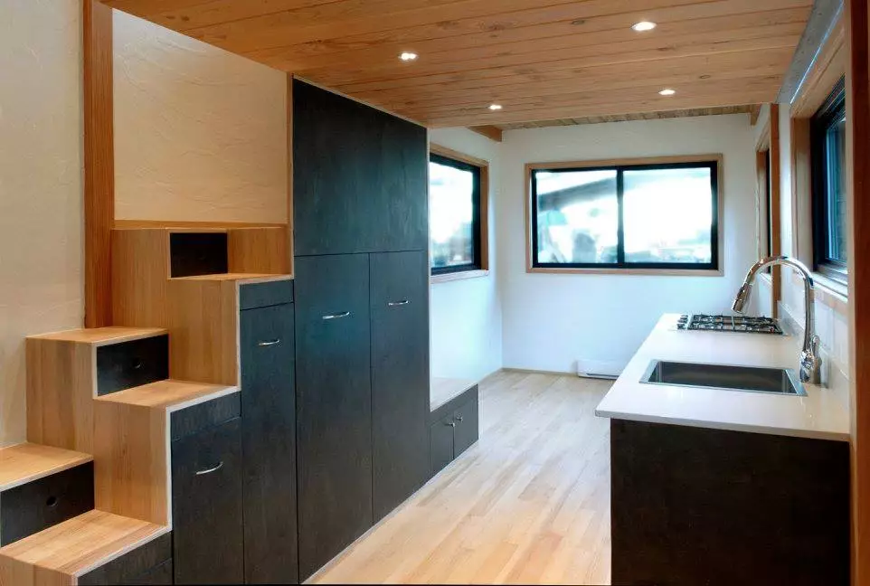 The staircase (with integrated storage) leads to a small upstairs loft