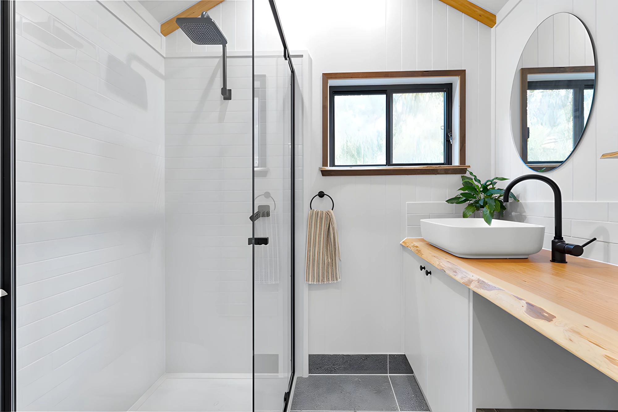 The Casuarina's bathroom includes a toilet, shower, and a vanity sink