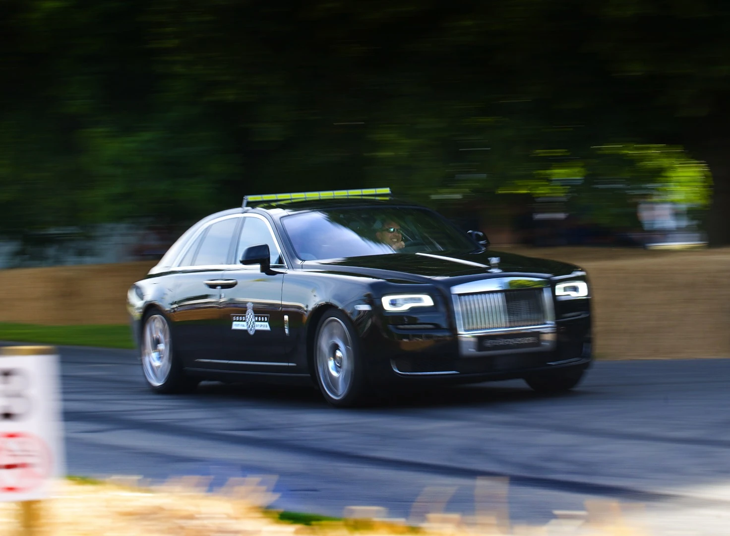 The Course Car this year was a Rolls-Royce Ghost Series II driven by the company's chief tester, David Monks. The roof-mounted LED race lights were handcrafted in aluminum at the Rolls-Royce plant. The Car was finished in Diamond Black, with an interior in Black and contrasting Hotspur Red leather and Black Stained Ash veneer